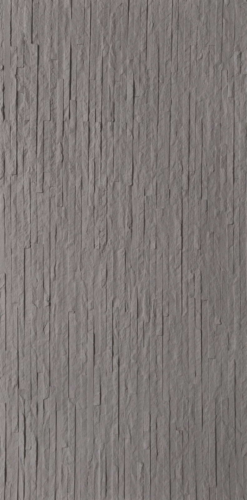 Close-up photograph of separate gray stone veneer strips arranged in a textured pattern